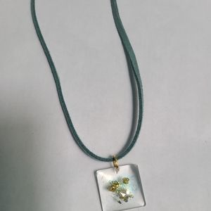 Blue cord necklace with resin charm
